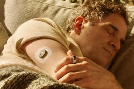 Man resting comfortably with CGM sensor monitoring glucose